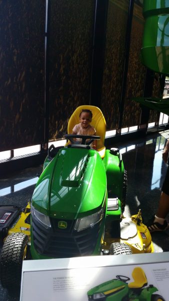 Posing on the equipment at the John Deere Museum