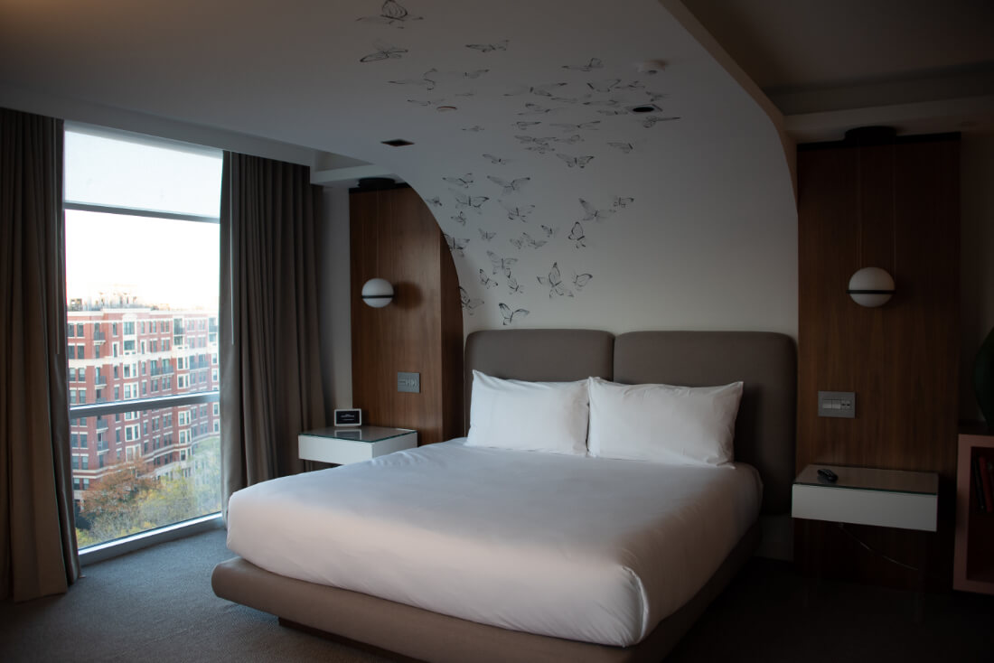 Hotel room at Hotel Zena in DC with an arched ceiling covered in butterflies over the bed