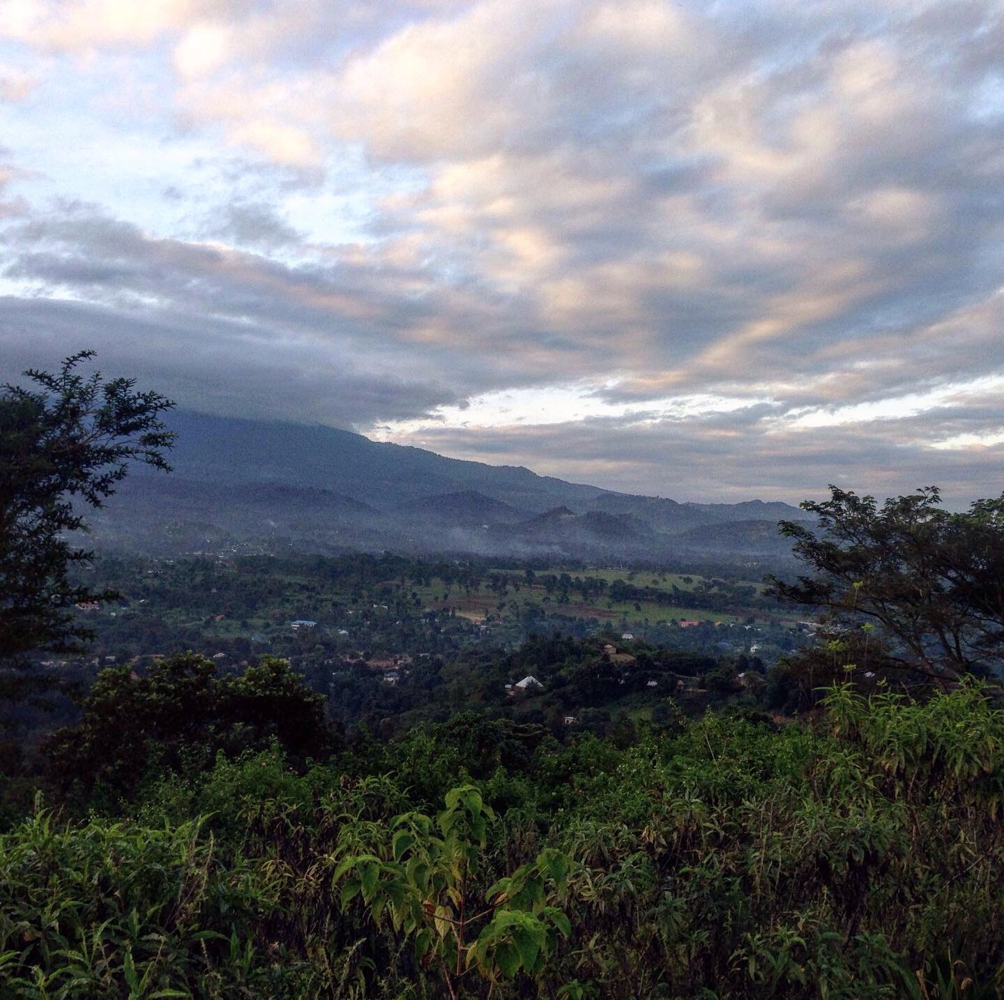 Visit Arusha, Tanzania for lovely views like this at dusk across the valley